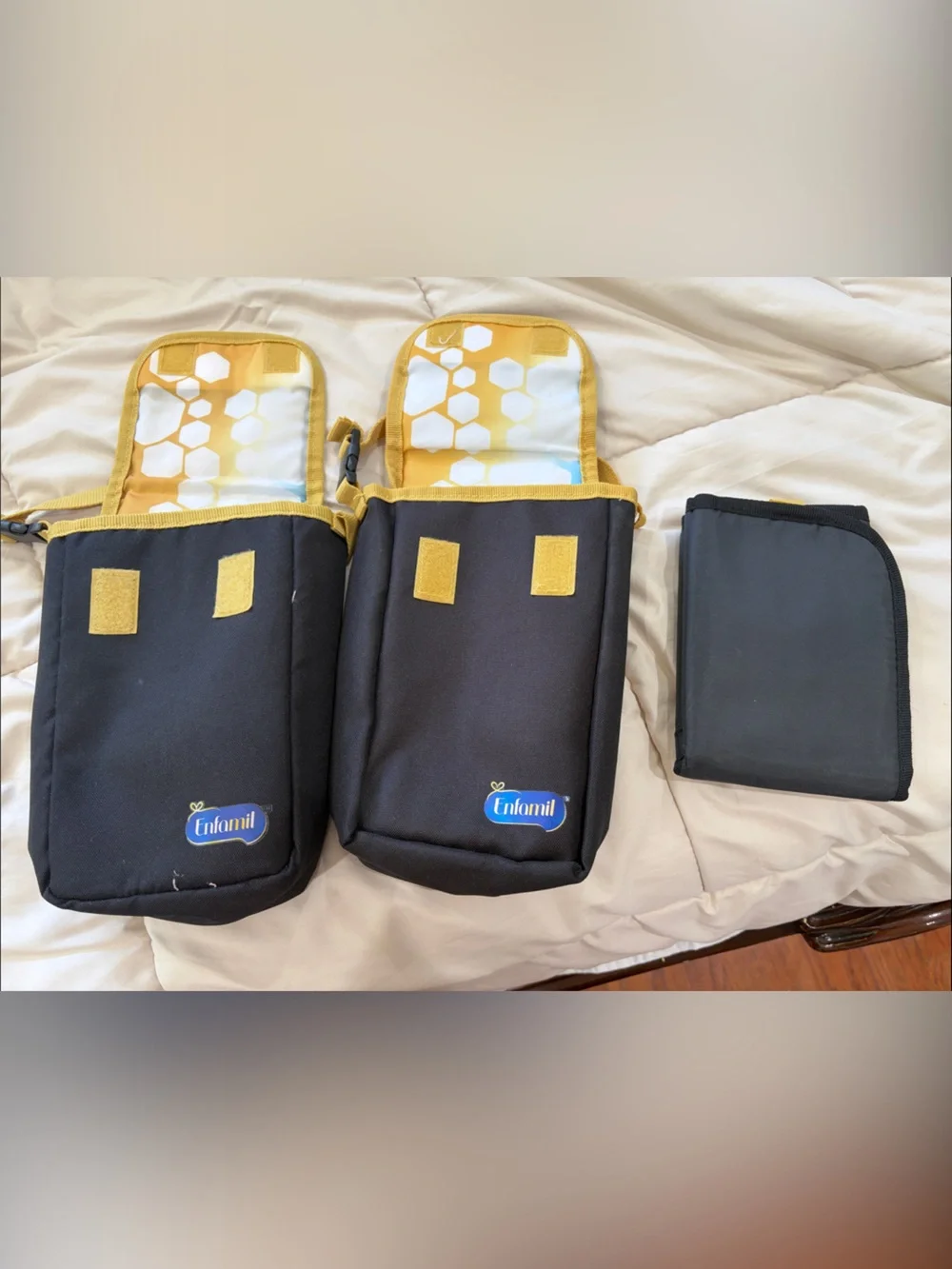 Two Enfamil milk bags/ Accessory Pouch. And a diaper changing pad brand new.